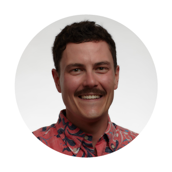 Smiling headshot of John Quinn, Director of Process Improvement at Nakupuna Companies, with a mustache, wearing a coral Hawaiian shirt.