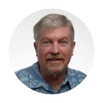 Smiling headshot of Pete Dwyer, Chief Investment Officer at Nakupuna Companies, with grey hair and a blue shirt.