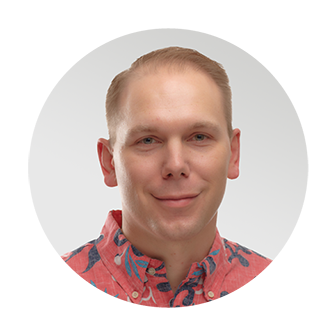 Friendly headshot of Jason Greenawalt, Chief Executive Officer at Nakupuna Companies, President of Na Ali'i, and the Vice Chair and Treasurer of the Nakupuna Foundation. He has short blond hair, wearing a coral-colored button-down shirt with a floral pattern.